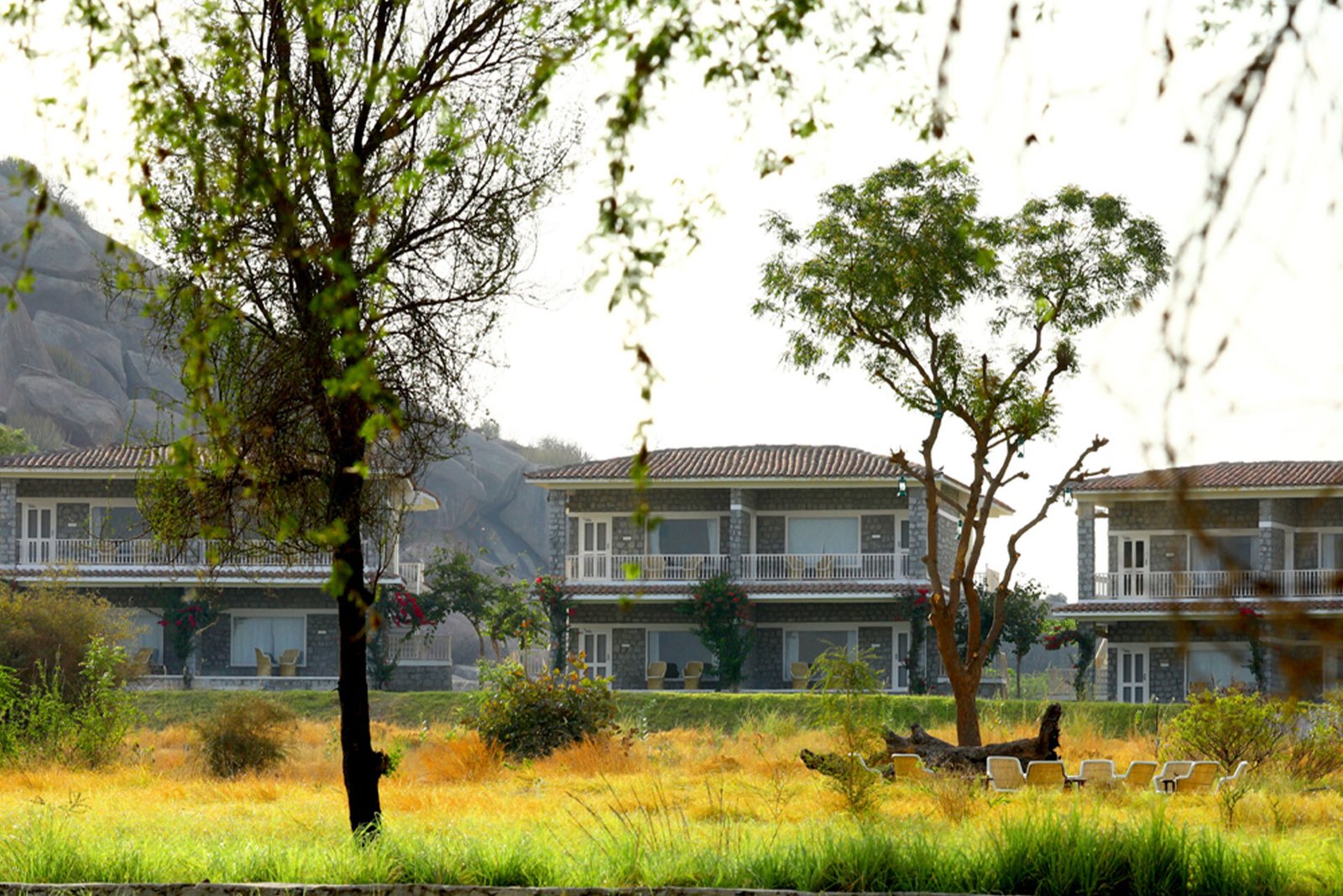The Jawai Sagar resort facade among granite hills